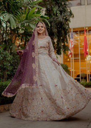 Rose gold and magenta toned lehenga with heavy handwork embellishment on the blouse and borders of lehenga