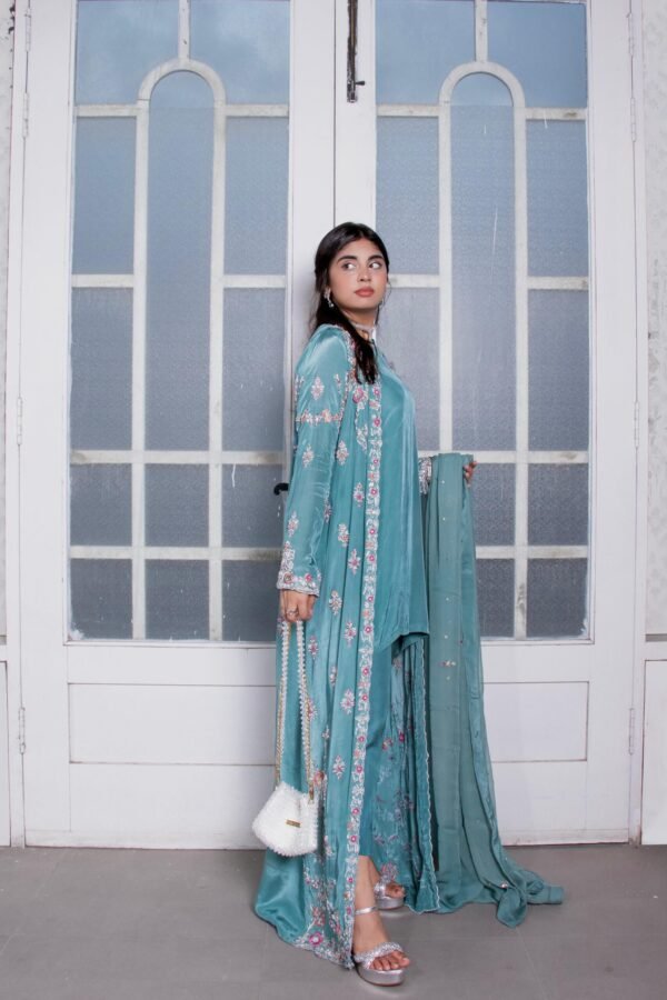A long embellished coat paired with cigarette pants, short shirt and embellished dupatta.
